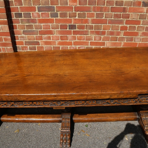 188 - A large Maple & Co oak extending refectory dining table, with relief carved geometric frieze, raised... 