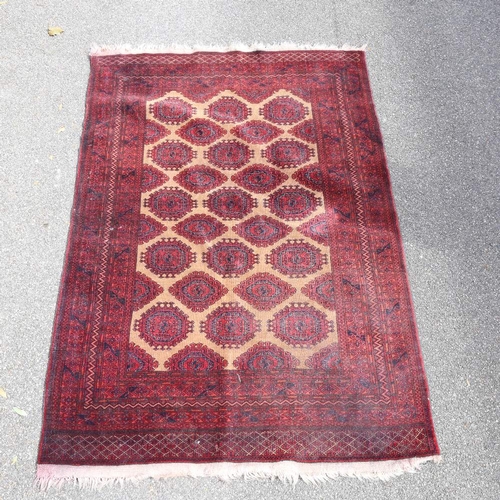 441 - An Antique red ground Tekke wool rug, 196cm x 132cm