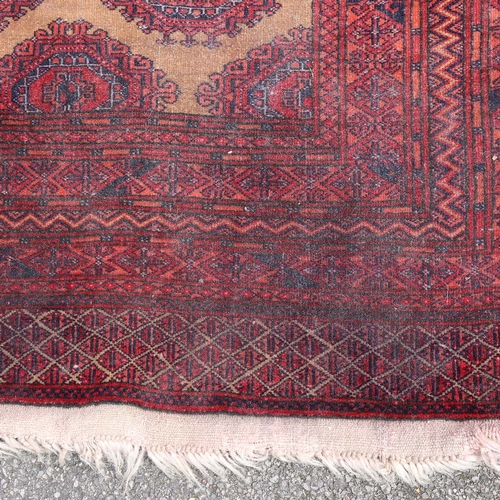 441 - An Antique red ground Tekke wool rug, 196cm x 132cm