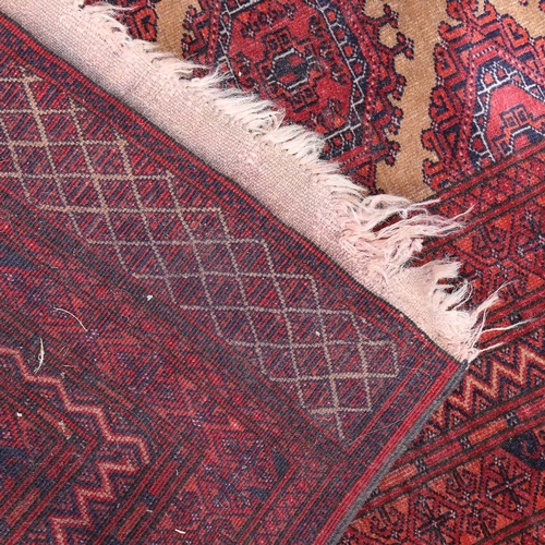 441 - An Antique red ground Tekke wool rug, 196cm x 132cm