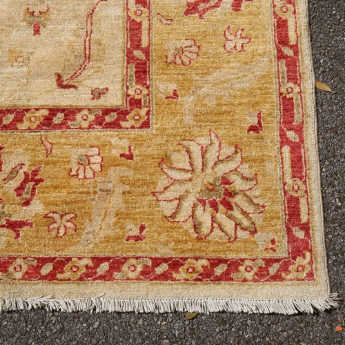 443 - A large cream ground Ziegler rug, 305cm x 242cm