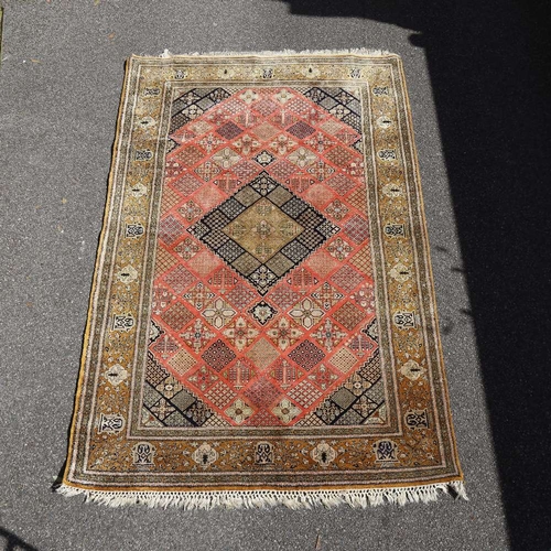 444 - An Iranian red and yellow ground silk rug, 210cm x 138cm