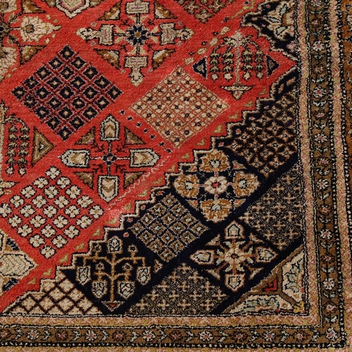 444 - An Iranian red and yellow ground silk rug, 210cm x 138cm