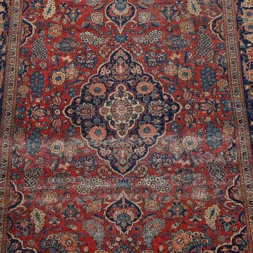 446 - An intricate antique red ground Persian rug, 200 x 135cm.