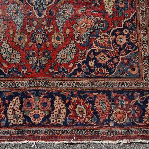 446 - An intricate antique red ground Persian rug, 200 x 135cm.