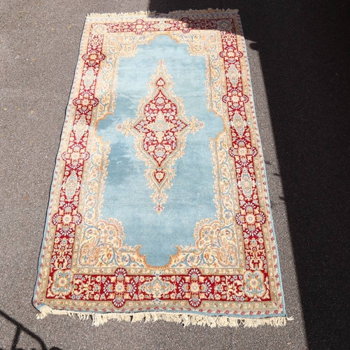 447 - An Iranian hand-woven blue ground wool rug, 270cm x 152cm