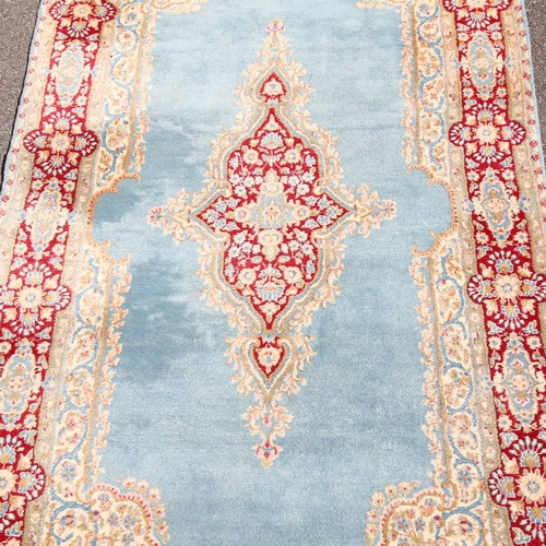 447 - An Iranian hand-woven blue ground wool rug, 270cm x 152cm