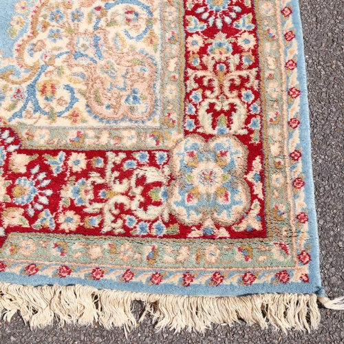 447 - An Iranian hand-woven blue ground wool rug, 270cm x 152cm