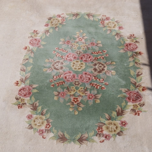 448 - A large Nepalese cream ground wool rug, floral centre and border, 410cm x 298cm