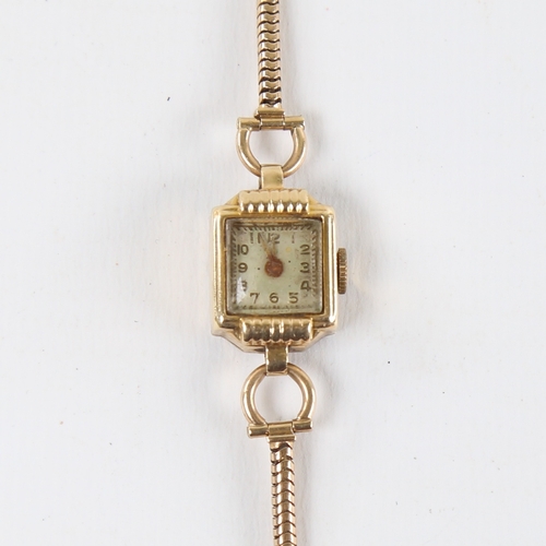 1040 - A lady's Vintage 14ct gold mechanical wristwatch, on 9ct snake link strap, not currently working, 12... 