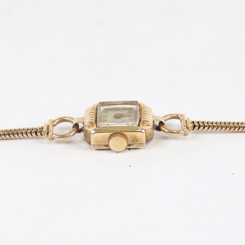 1040 - A lady's Vintage 14ct gold mechanical wristwatch, on 9ct snake link strap, not currently working, 12... 