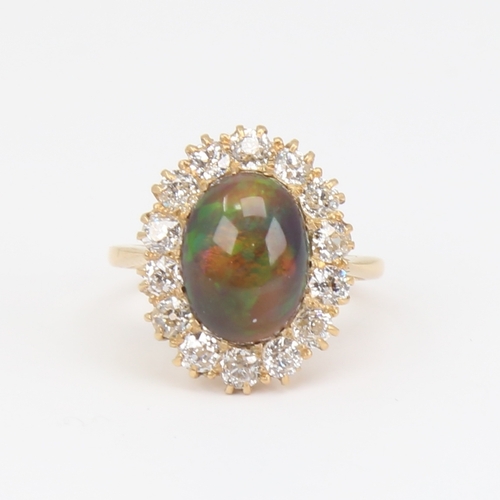 1101 - An early 20th century 18ct gold black opal and diamond cluster ring, set with oval high cabochon bla... 