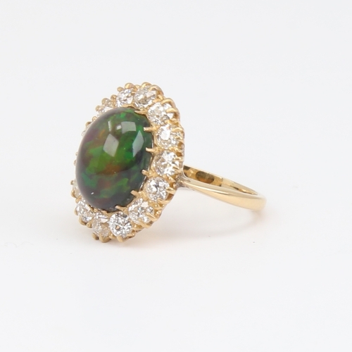 1101 - An early 20th century 18ct gold black opal and diamond cluster ring, set with oval high cabochon bla... 