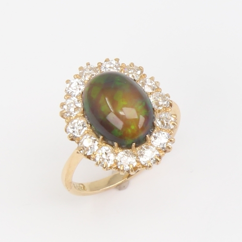 1101 - An early 20th century 18ct gold black opal and diamond cluster ring, set with oval high cabochon bla... 