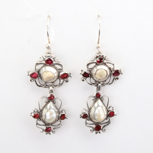 1103 - A pair of Dutch Georgian unmarked silver pearl and flat-top garnet pendant earrings, openwork scroll... 