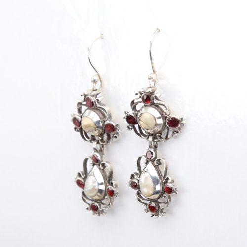 1103 - A pair of Dutch Georgian unmarked silver pearl and flat-top garnet pendant earrings, openwork scroll... 