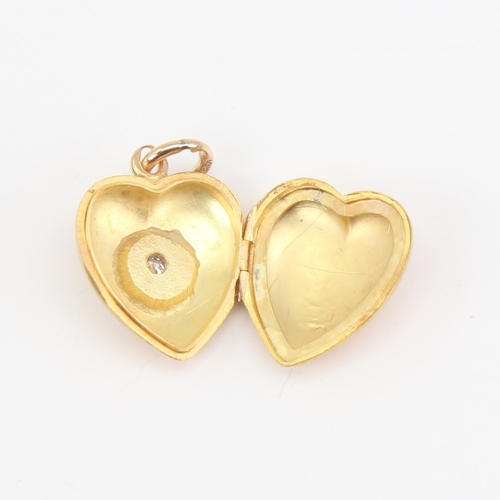 1106 - A Victorian 18ct gold diamond set heart locket pendant, set with old-cut diamond and 15ct bale, heig... 