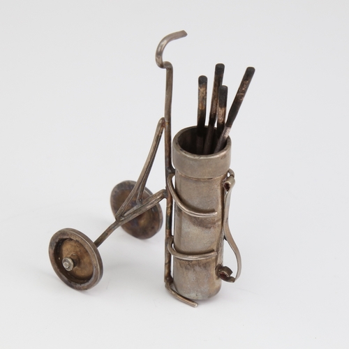 1110 - An Elizabeth II novelty silver miniature set of golf clubs and caddy, by Edward Victor Stanley, hall... 