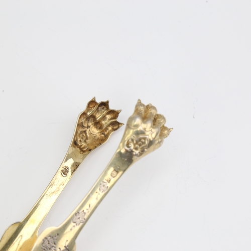 1111 - A pair of 19th century French silver-gilt lion paw sugar tongs, bright-cut engraved floral decoratio... 