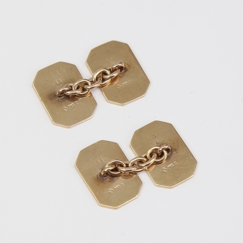 1118 - A pair of 9ct gold cufflinks, canted rectangular form with engine turned decoration, panel length 16... 