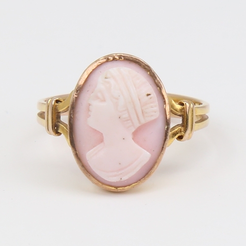 1119 - An unmarked gold relief carved pink coral cameo ring, depicting female profile, setting height 16mm,... 