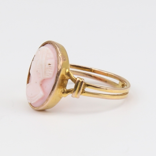 1119 - An unmarked gold relief carved pink coral cameo ring, depicting female profile, setting height 16mm,... 