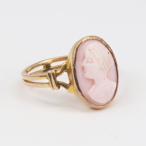 1119 - An unmarked gold relief carved pink coral cameo ring, depicting female profile, setting height 16mm,... 