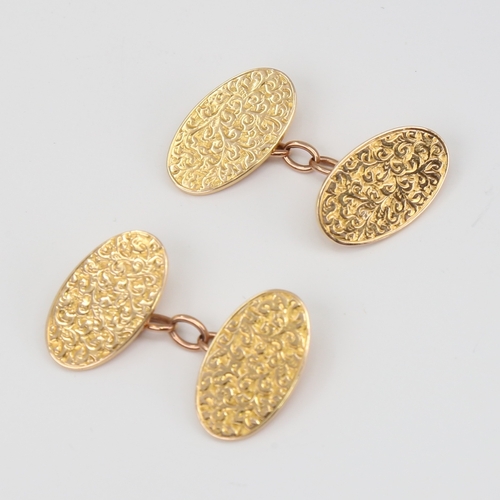 1120 - A pair of late 19th century 15ct gold cufflinks, oval panels with engraved foliate decoration, by BH... 