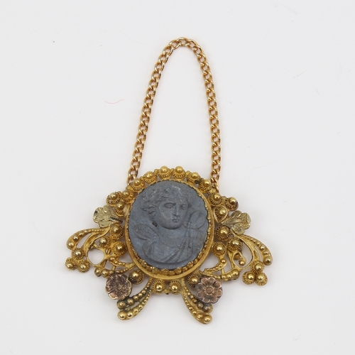 1121 - A Victorian unmarked gold lava cameo pendant, relief carved panel depicting Classical female bust wi... 