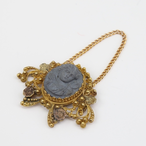 1121 - A Victorian unmarked gold lava cameo pendant, relief carved panel depicting Classical female bust wi... 