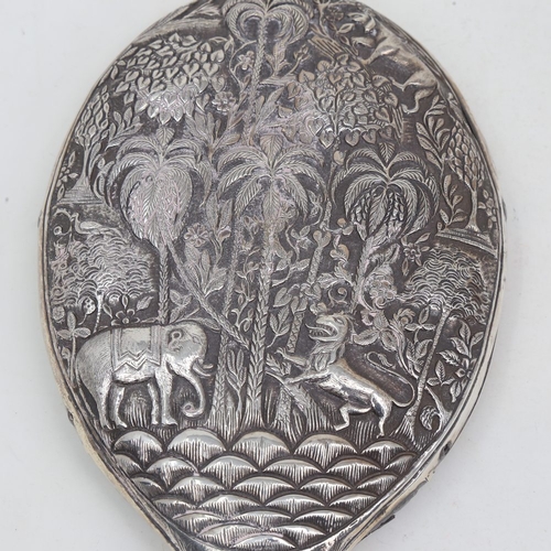 1124 - An unmarked Indian silver dressing table hand mirror, allover relief embossed animal and jungle deco... 