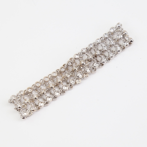 1130 - A modern 18ct white gold diamond triple-line bracelet, set with modern round brilliant-cut diamonds,... 