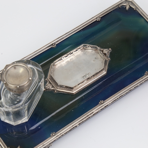 1132 - An Edwardian polished blue agate and silver inkwell desk stand, with removeable cut-glass silver-mou... 