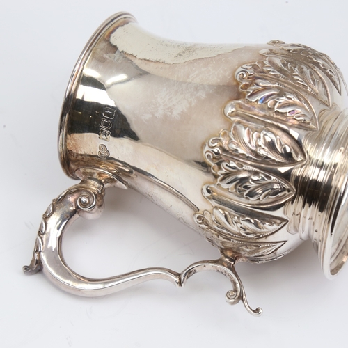 1133 - An Edwardian silver half pint tankard mug, cylindrical baluster form with relief embossed acanthus l... 