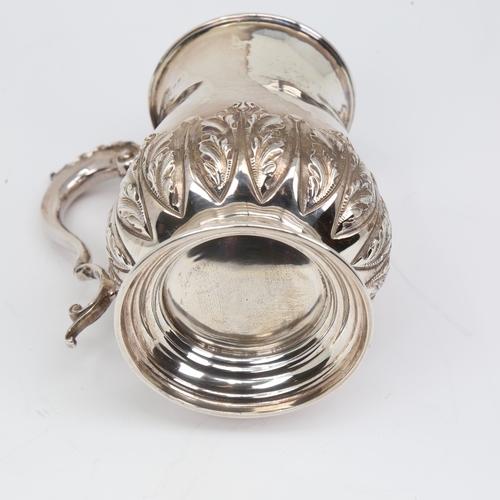 1133 - An Edwardian silver half pint tankard mug, cylindrical baluster form with relief embossed acanthus l... 