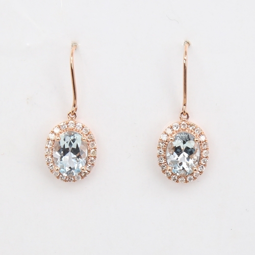 1135 - A modern pair of 14ct rose gold aquamarine and diamond cluster pendant earrings, set with oval-cut a... 