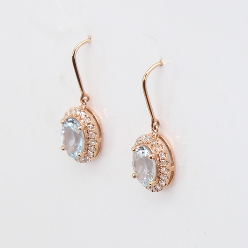 1135 - A modern pair of 14ct rose gold aquamarine and diamond cluster pendant earrings, set with oval-cut a... 