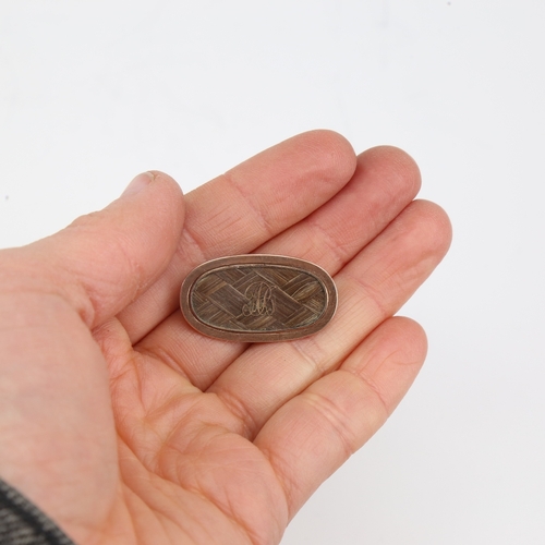 1144 - A Georgian oval mourning brooch, unmarked gold settings with lattice woven hair panel and applied go... 