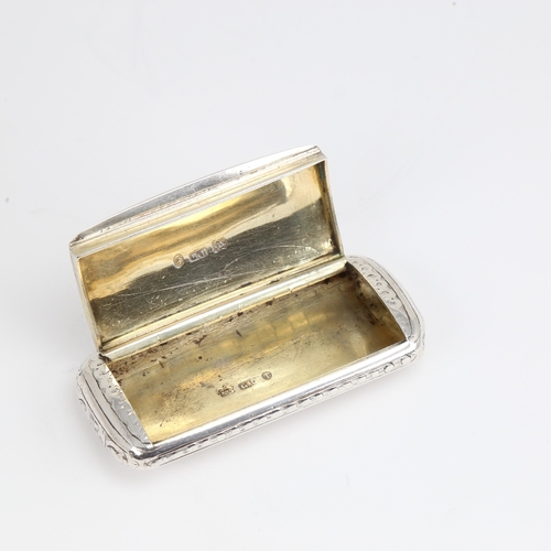 1161 - A Victorian silver snuffbox, rectangular cushion form with bright-cut engraved decoration and gilt i... 