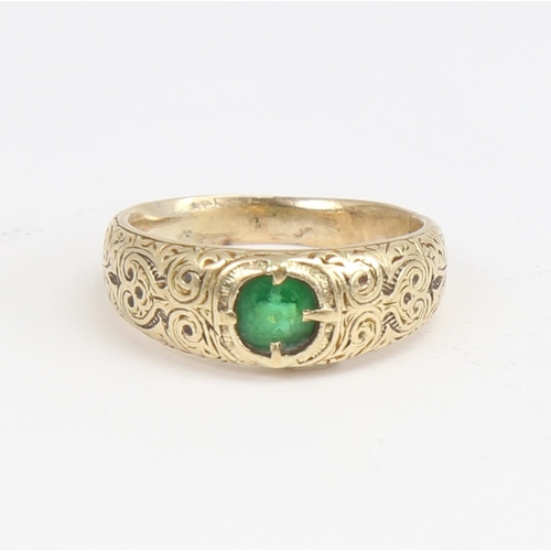 1164 - An Antique unmarked high carat gold green stone set ring, ornate engraved shoulders and shank, setti... 