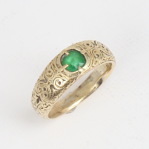 1164 - An Antique unmarked high carat gold green stone set ring, ornate engraved shoulders and shank, setti... 