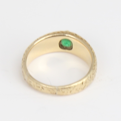 1164 - An Antique unmarked high carat gold green stone set ring, ornate engraved shoulders and shank, setti... 