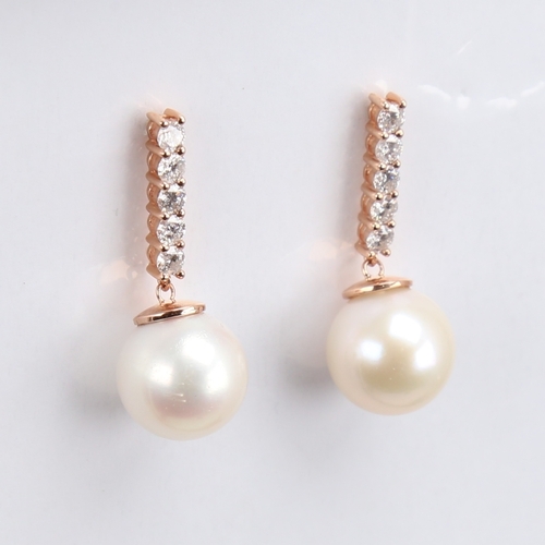 1171 - A modern pair of 14ct rose gold whole cultured pearl and diamond drop earrings, set with a line of m... 