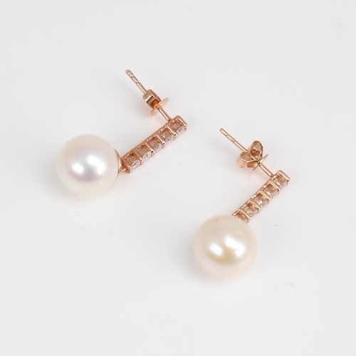 1171 - A modern pair of 14ct rose gold whole cultured pearl and diamond drop earrings, set with a line of m... 