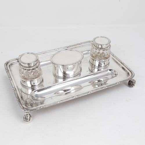 1178 - A George V silver deskstand, rectangular form with pen trays, 2 silver-mounted glass inkwells and st... 