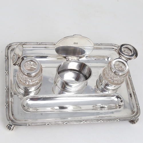 1178 - A George V silver deskstand, rectangular form with pen trays, 2 silver-mounted glass inkwells and st... 