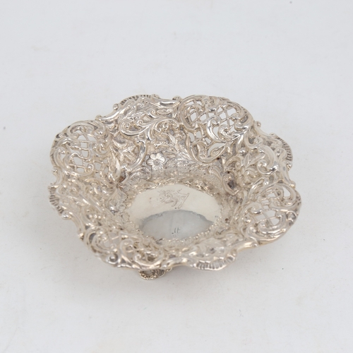 1180 - A small Victorian silver bon bon dish, relief embossed floral decoration with pierced lattice raised... 