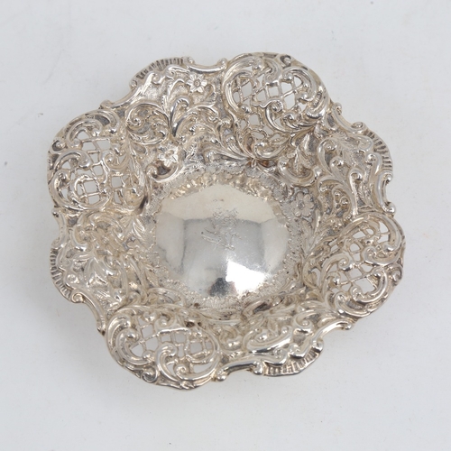 1180 - A small Victorian silver bon bon dish, relief embossed floral decoration with pierced lattice raised... 