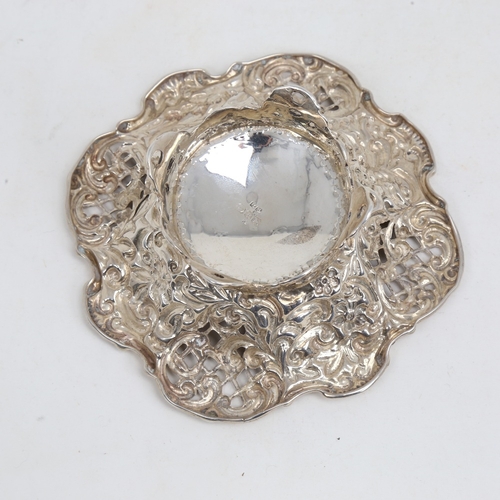 1180 - A small Victorian silver bon bon dish, relief embossed floral decoration with pierced lattice raised... 