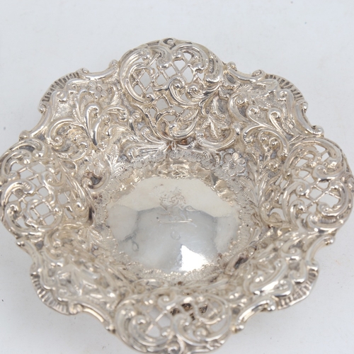 1180 - A small Victorian silver bon bon dish, relief embossed floral decoration with pierced lattice raised... 